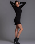 A woman modeling the One Golden Thread Reversible Little Black Dress