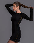 A woman modeling the One Golden Thread Reversible Little Black Dress
