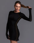 A woman modeling the One Golden Thread Reversible Little Black Dress