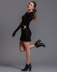 A woman modeling the One Golden Thread Reversible Little Black Dress