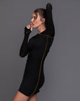 A woman modeling the One Golden Thread Reversible Little Black Dress