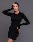 A woman modeling the One Golden Thread Reversible Little Black Dress