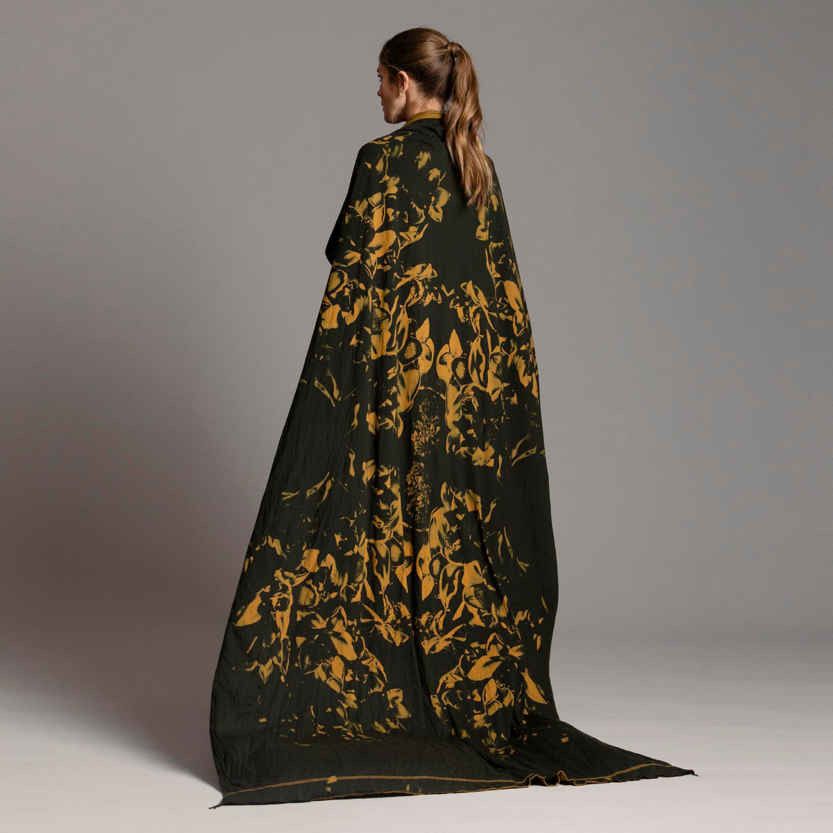 Woman modeling gold Benzova pattern nature wrap