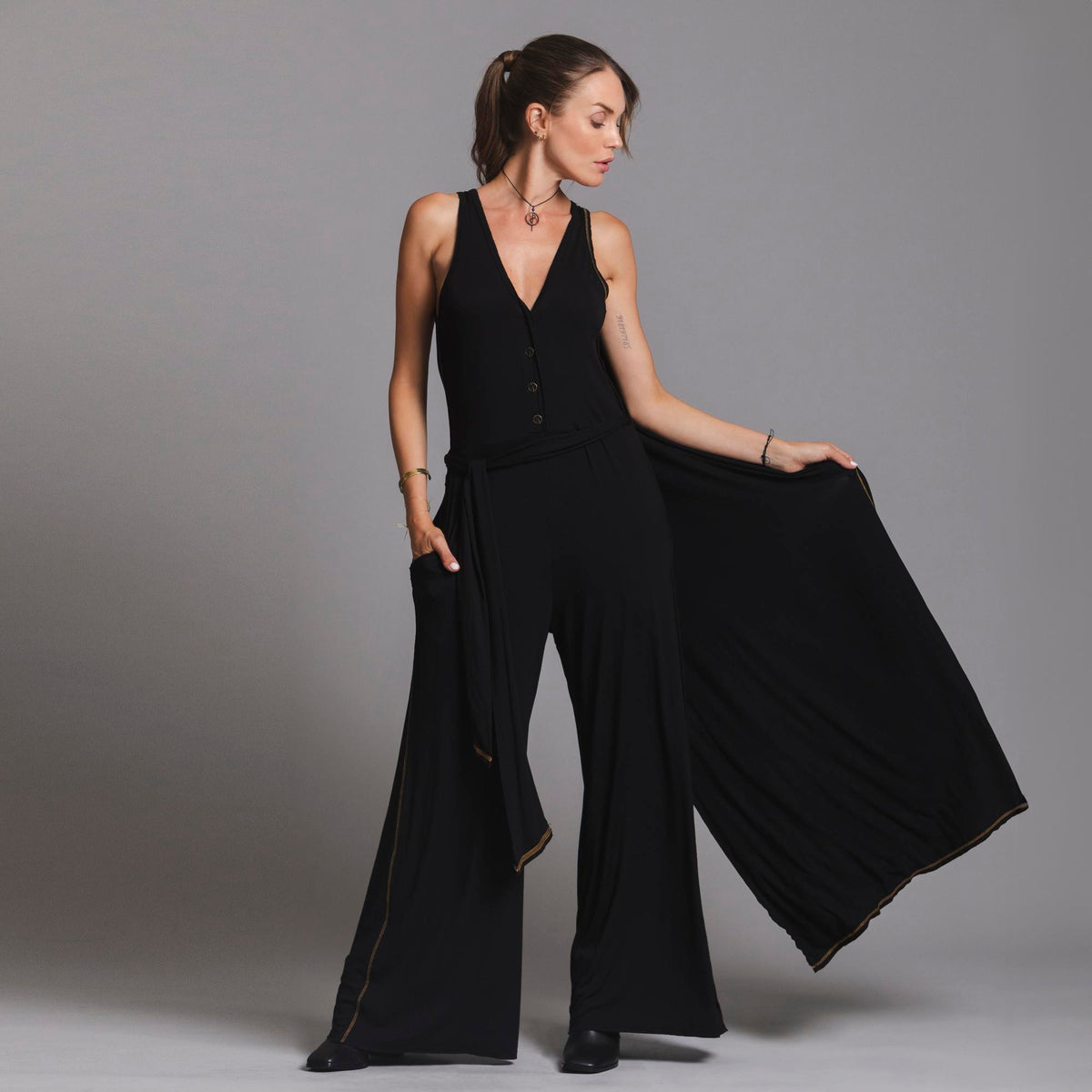 woman modeling the infinite bodysuit in black
