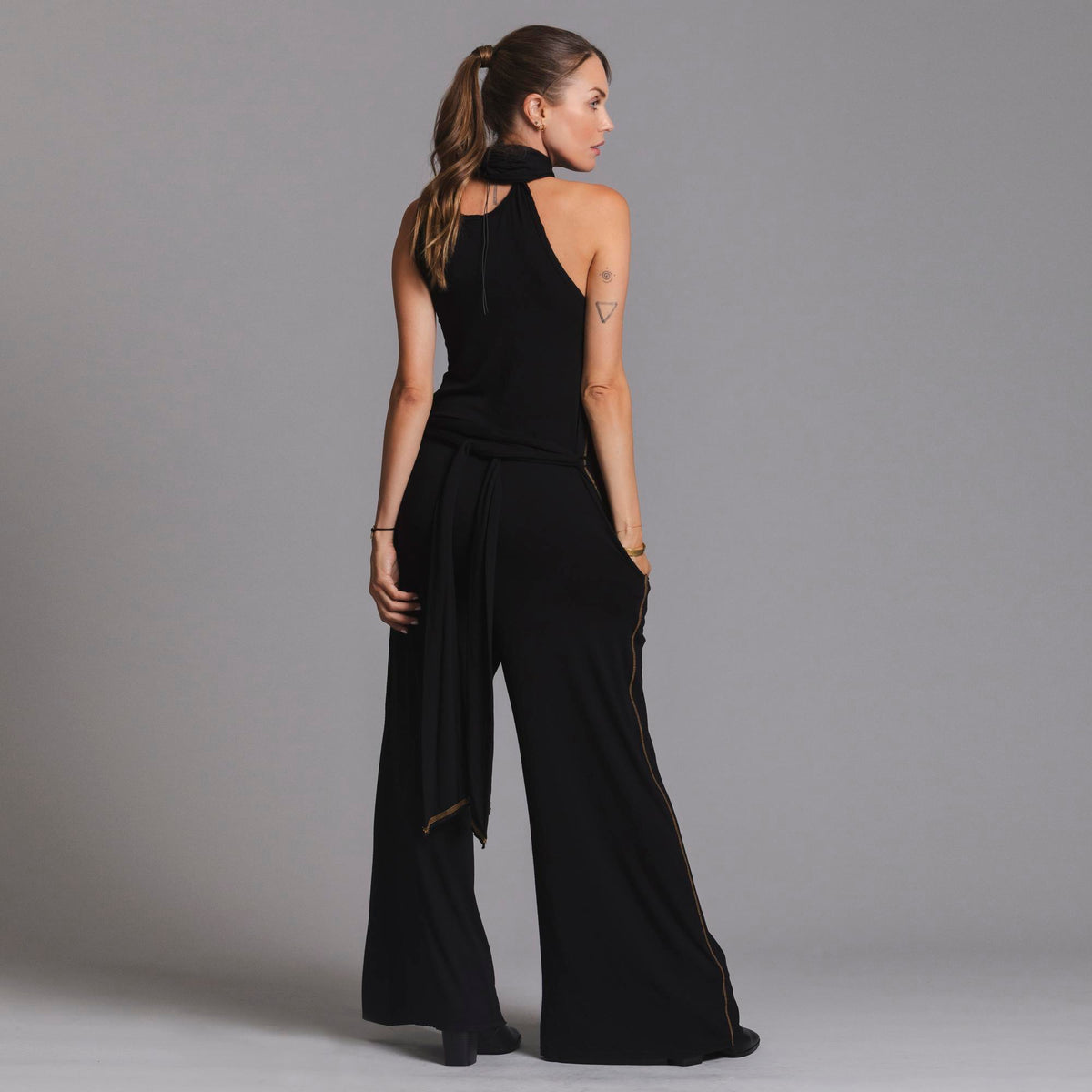 woman modeling the infinite bodysuit in black