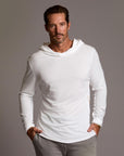 Man modeling white long-sleeve hooded tee
