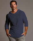 Man modeling blue long-sleeve hooded tee