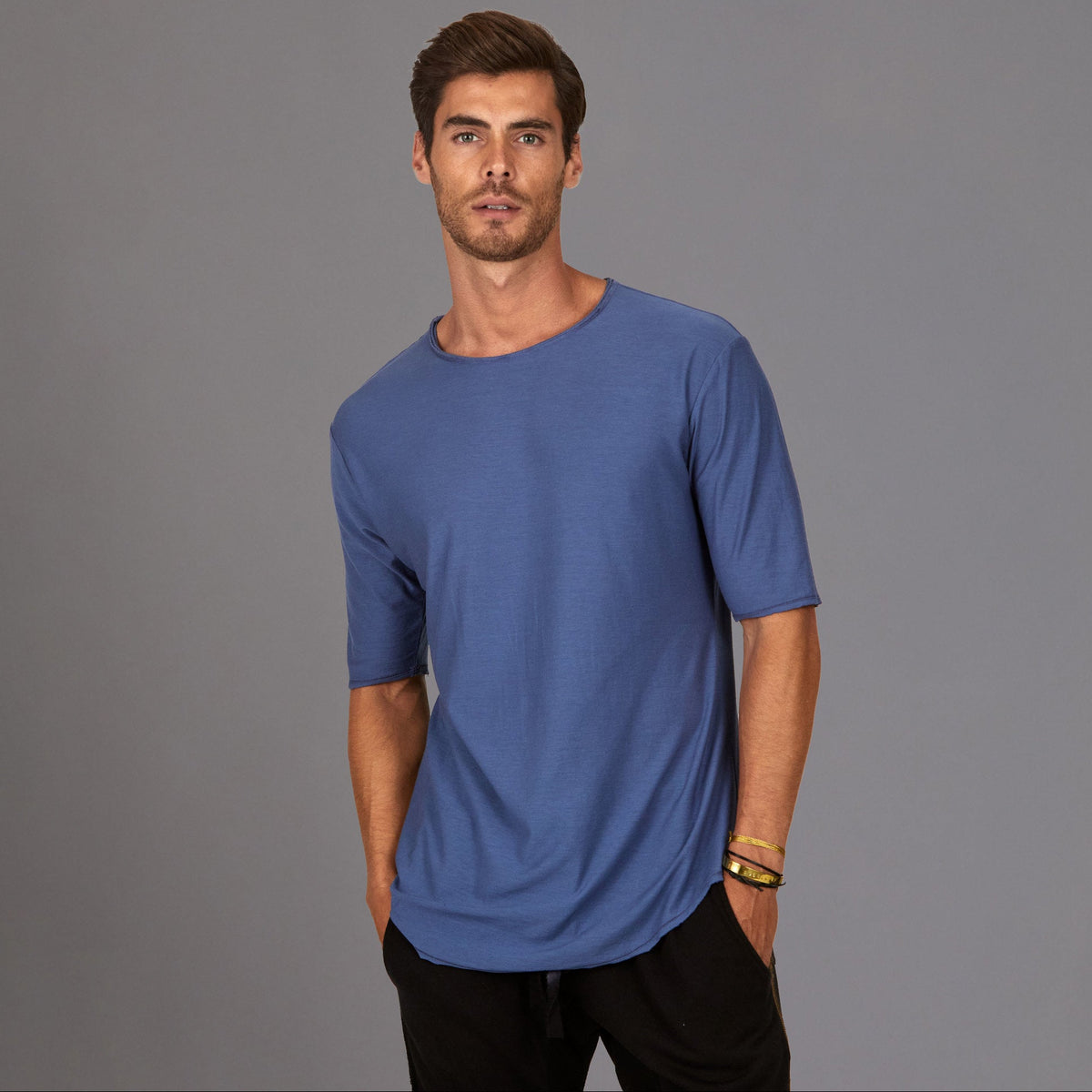 Male modeling blue crew neck shirt