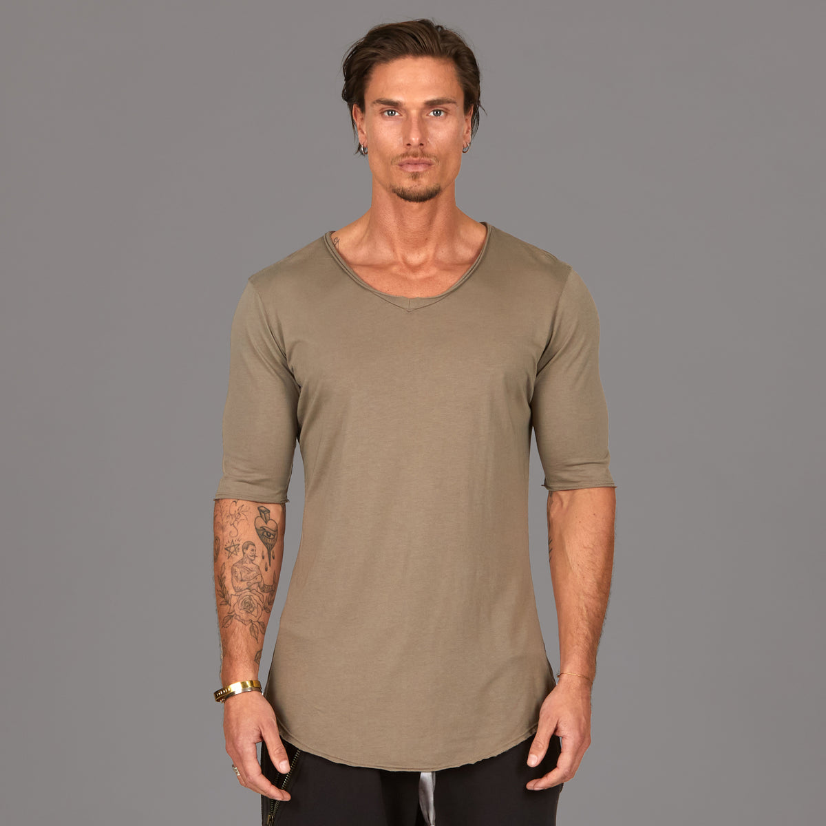 Male modeling tan v neck shirt 