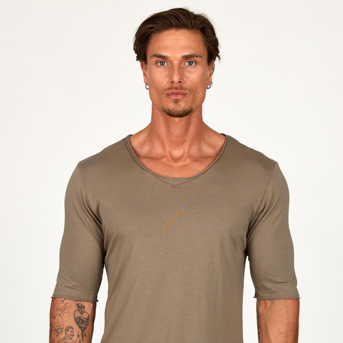 Male modeling tan v neck shirt 