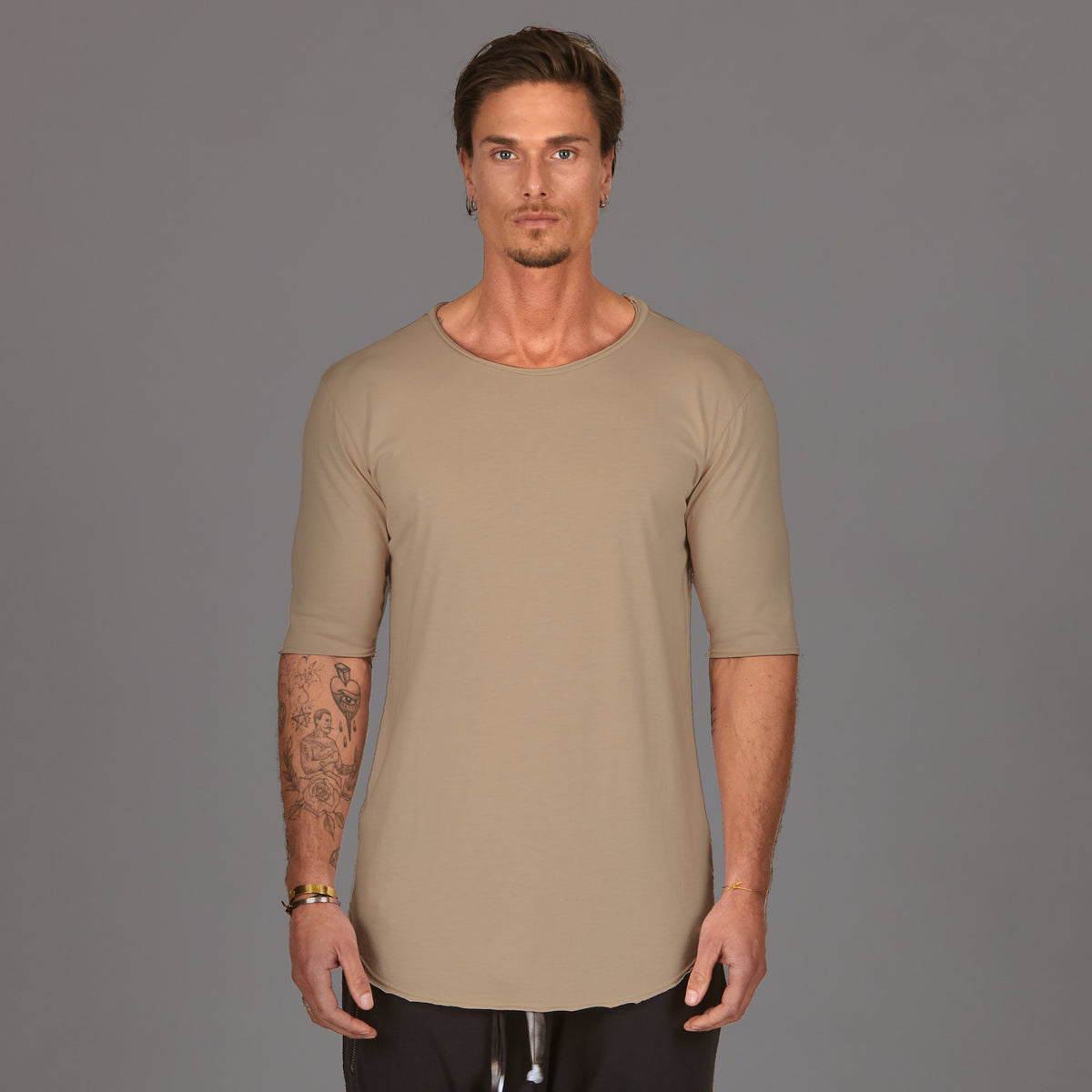 Male modeling tan crew neck shirt