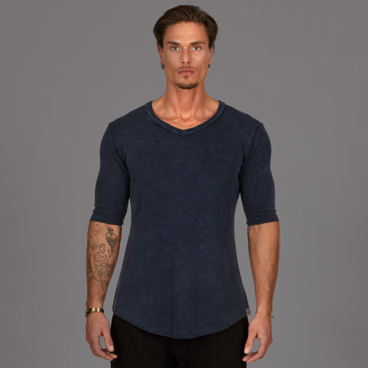 A man wearing the One Golden Thread Fleece Sweater v neck shirt in the blue mineral color