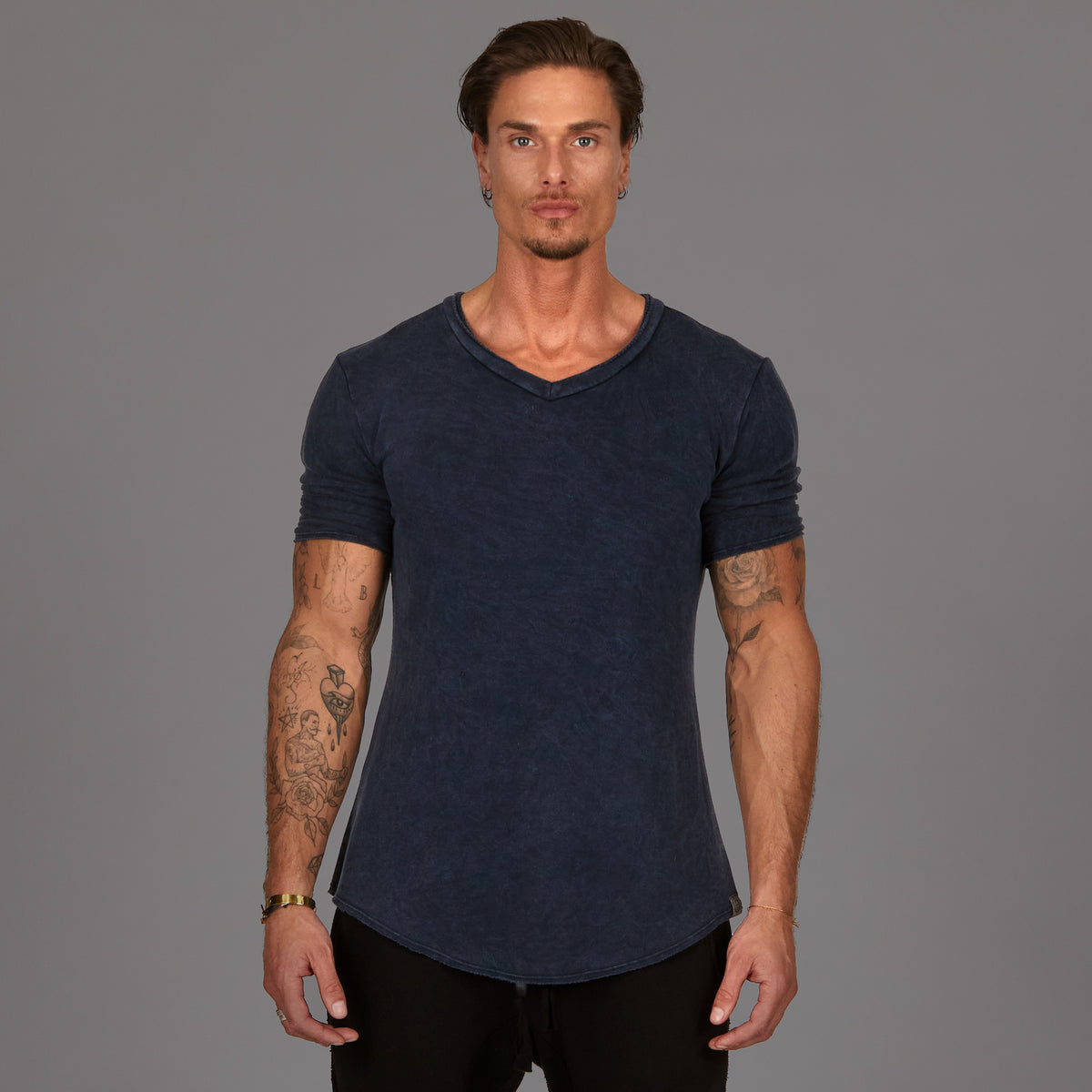 A man wearing the One Golden Thread Fleece Sweater v neck shirt in the blue mineral color