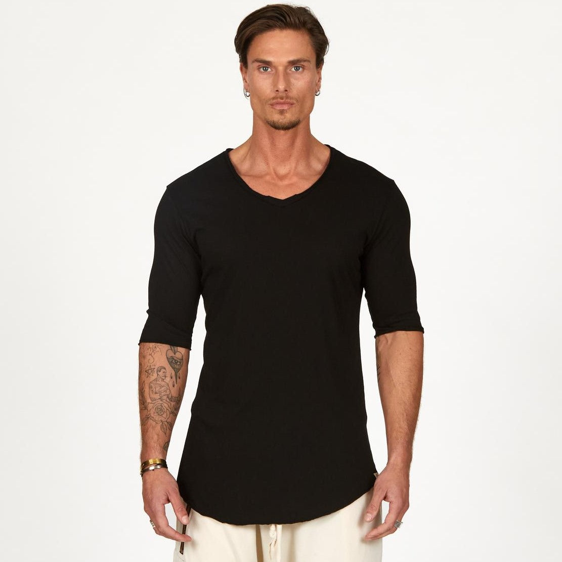Man modeling a mid sleeve V Neck shirt in black