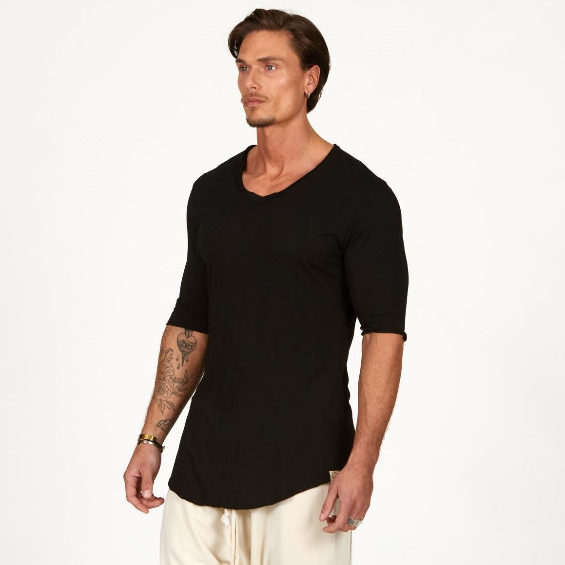 Man modeling a mid sleeve shirt in black