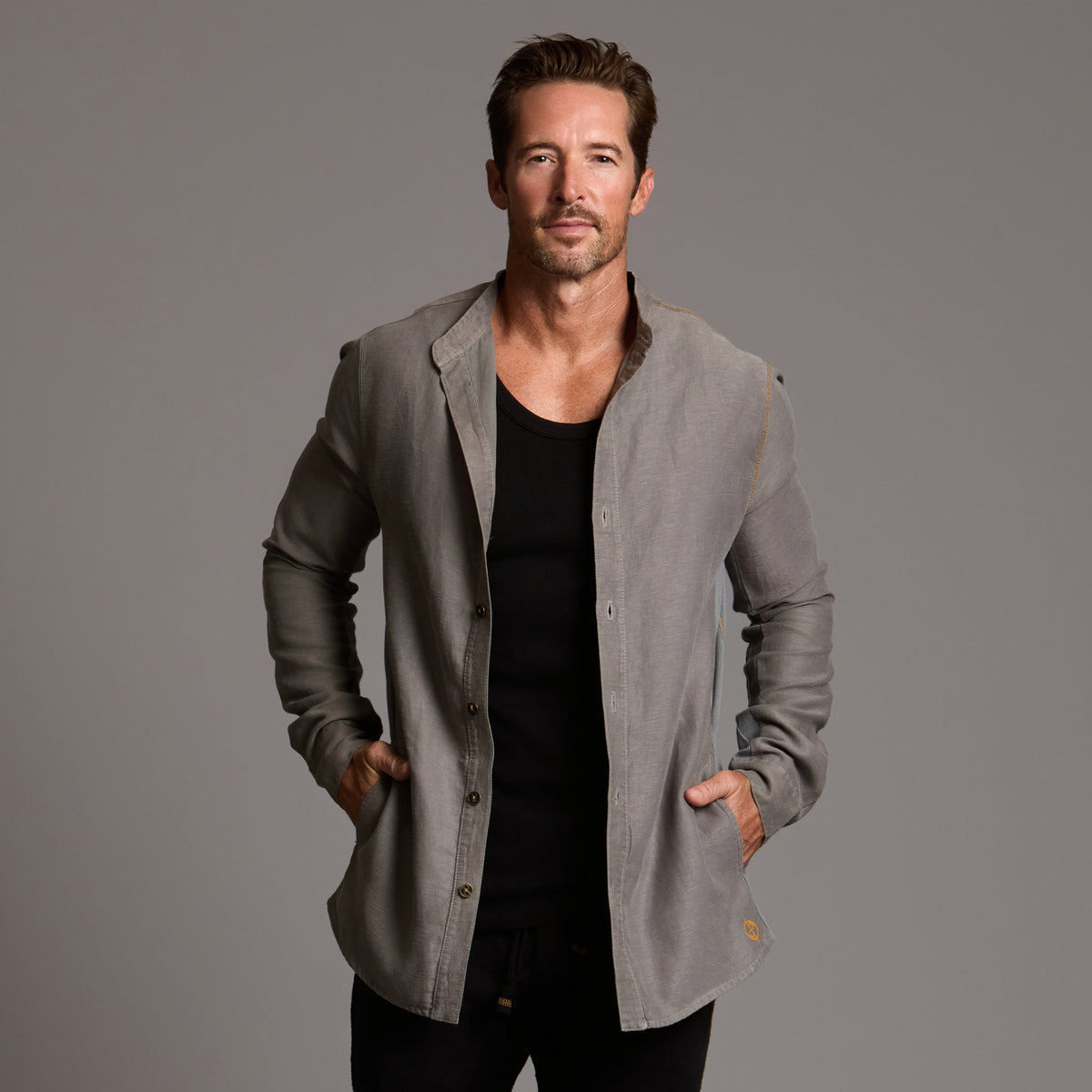 Male modeling Shacket in River Rock