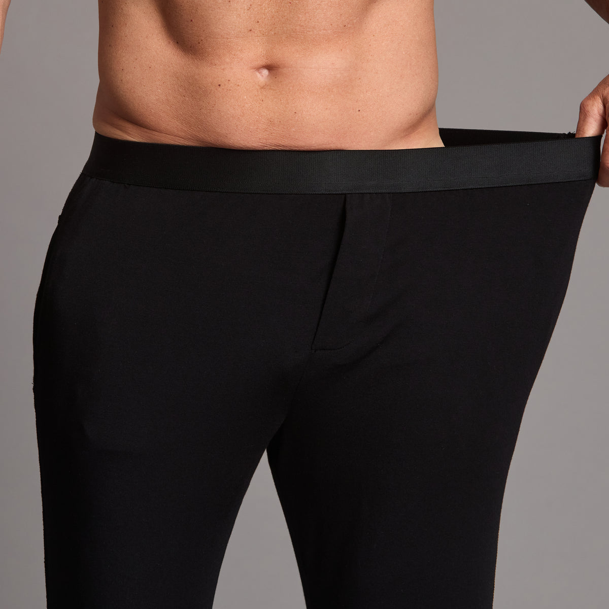 Male modeling the black tree silk pant