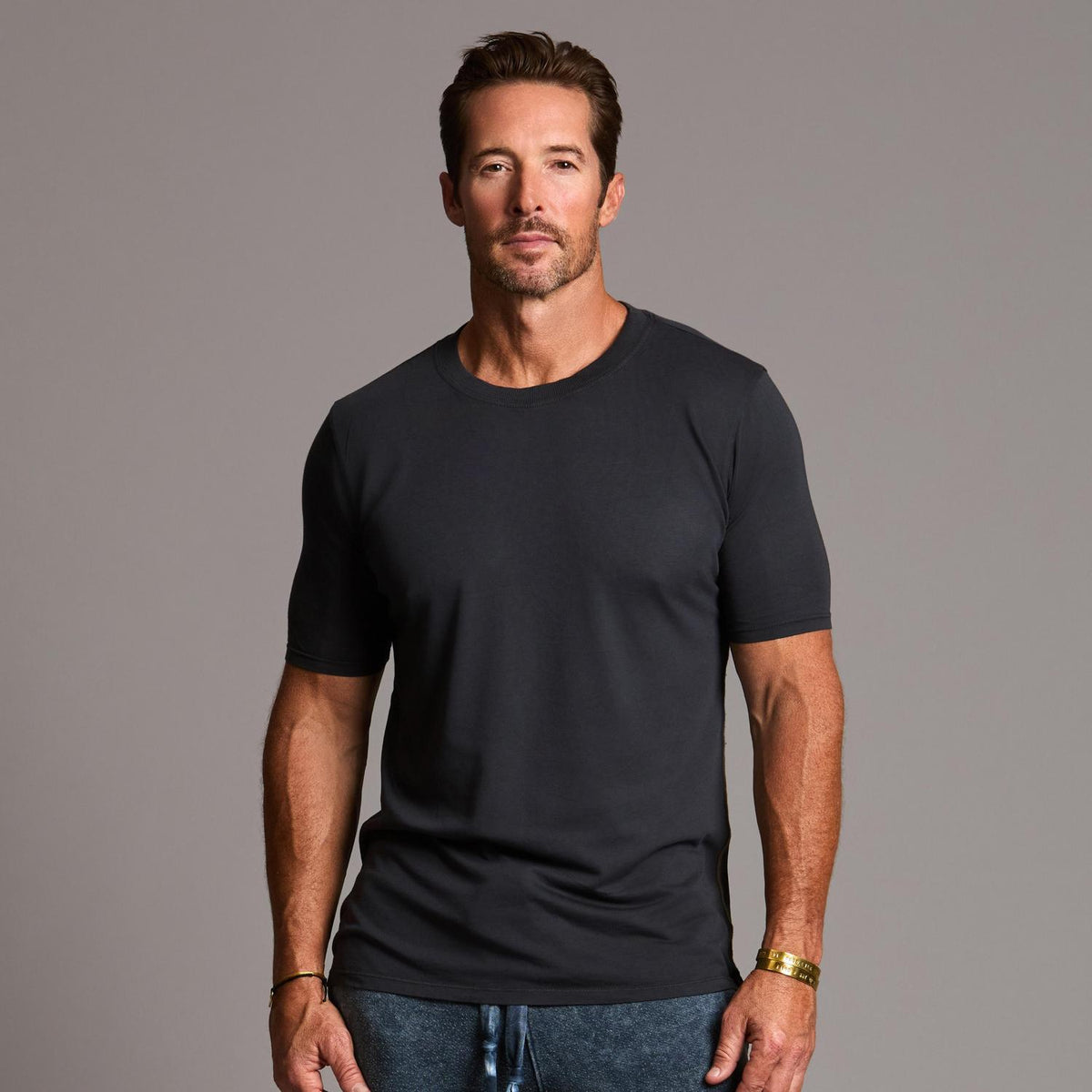 man modeling a tee in charcoal blue