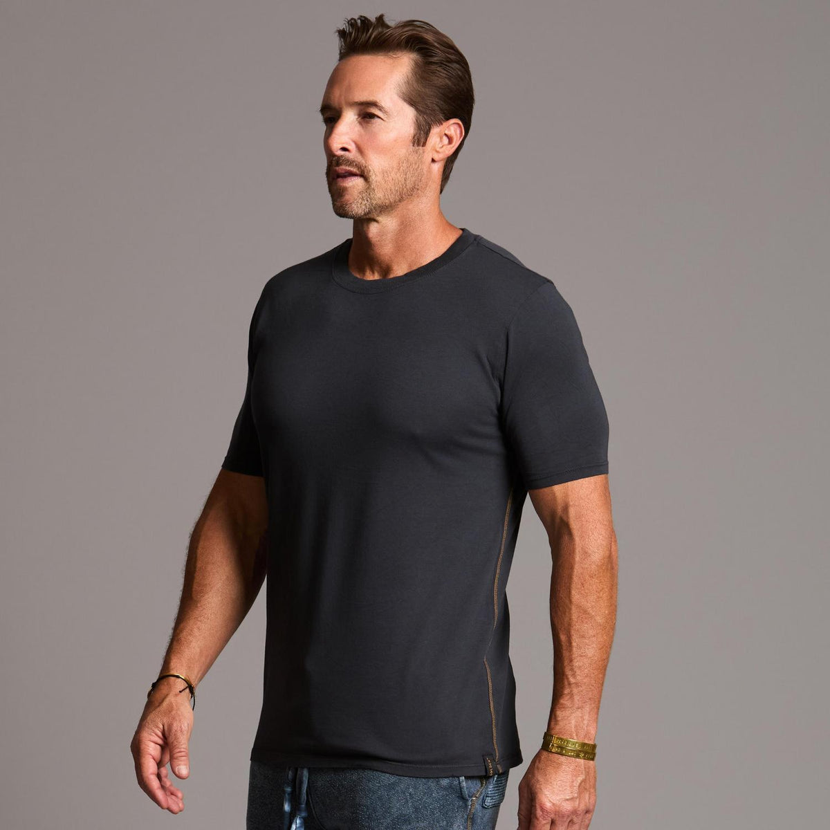 man modeling a tee in charcoal blue