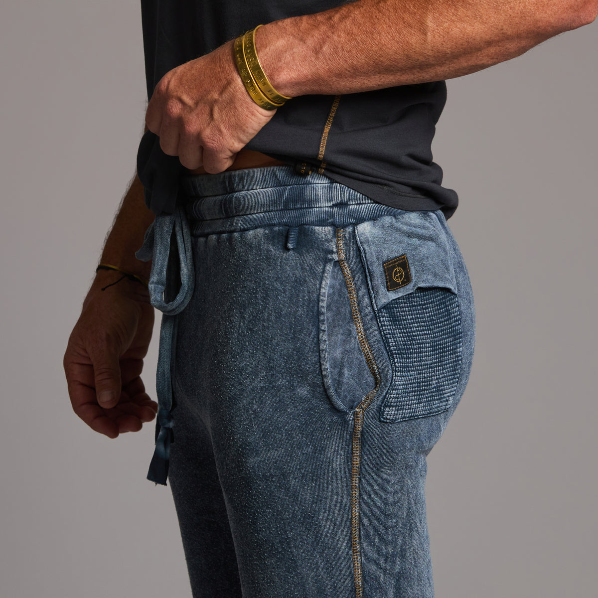 man modeling pants in mineral blue