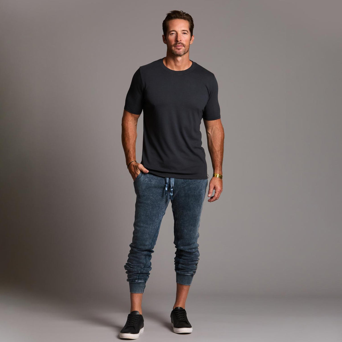 man modeling pants in mineral blue