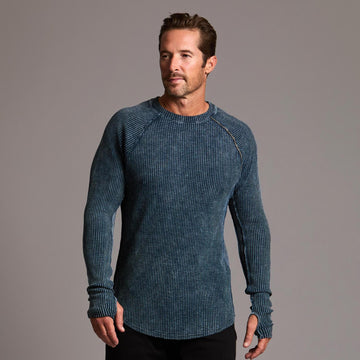 A man modeling a One Golden Thread Waffle Long Sleeve Raglan shirt in blue mineral