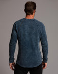 A man modeling a One Golden Thread Waffle Long Sleeve Raglan shirt in blue mineral