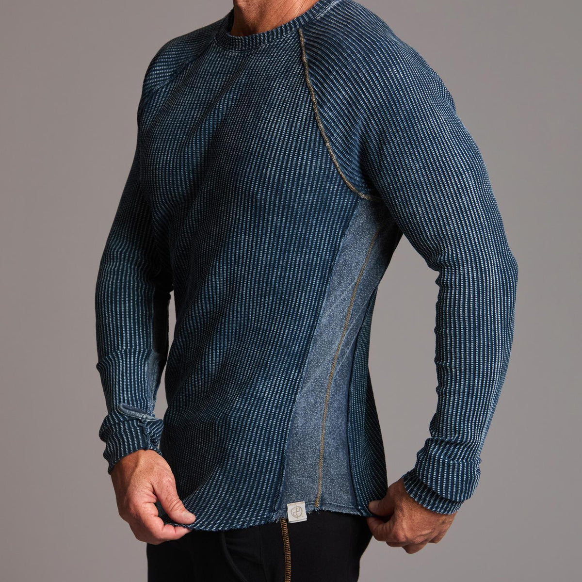 A man modeling a One Golden Thread Waffle Long Sleeve Raglan shirt in blue mineral