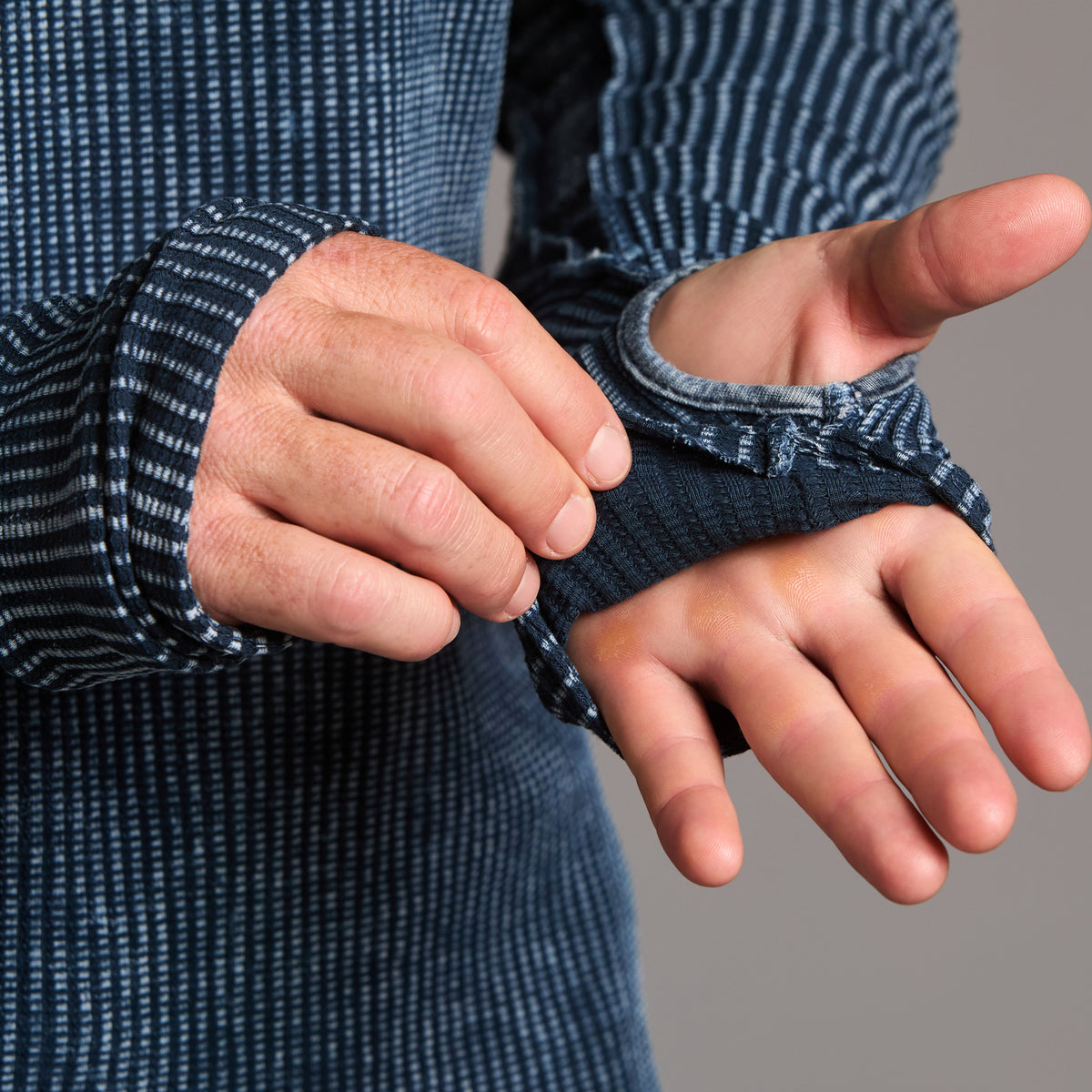 A man modeling a One Golden Thread Waffle Long Sleeve Raglan shirt in blue mineral