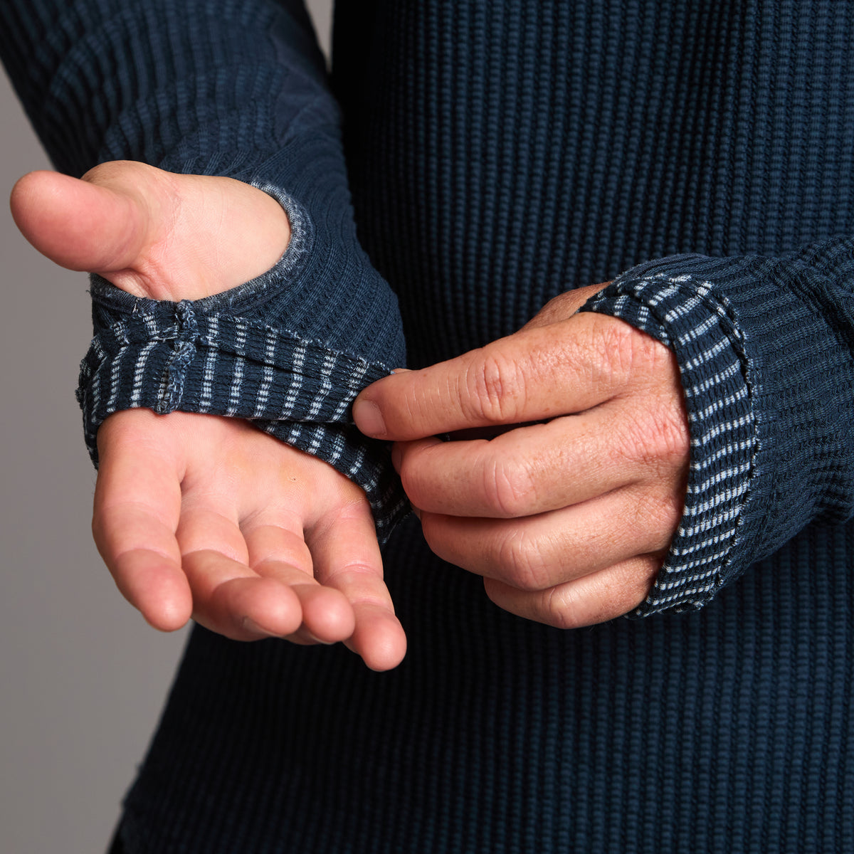 A man modeling a One Golden Thread Waffle Long Sleeve Raglan shirt in blue mineral