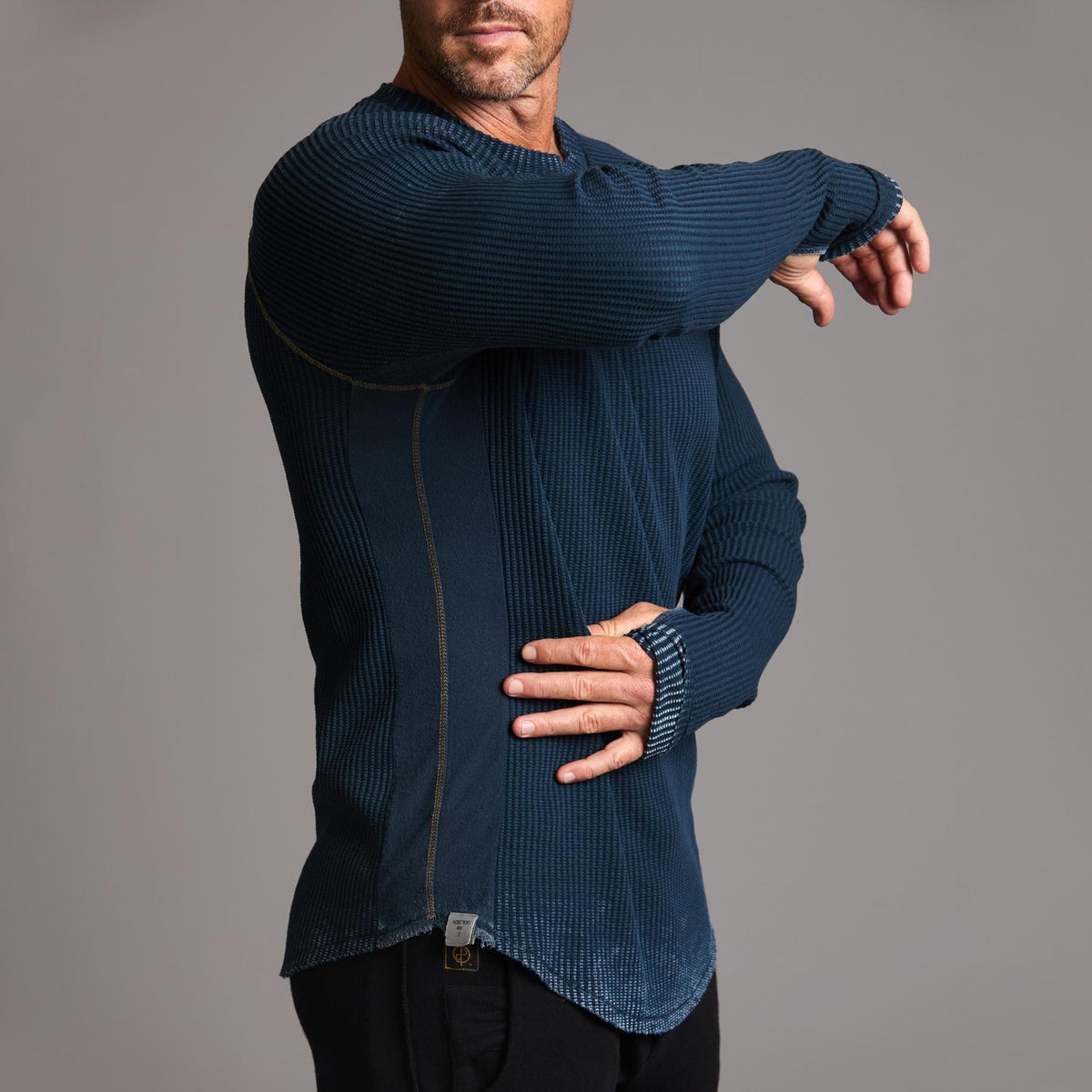 A man modeling a One Golden Thread Waffle Long Sleeve Raglan shirt in blue mineral