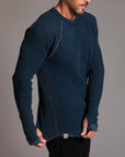 A man modeling a One Golden Thread Waffle Long Sleeve Raglan shirt in blue mineral