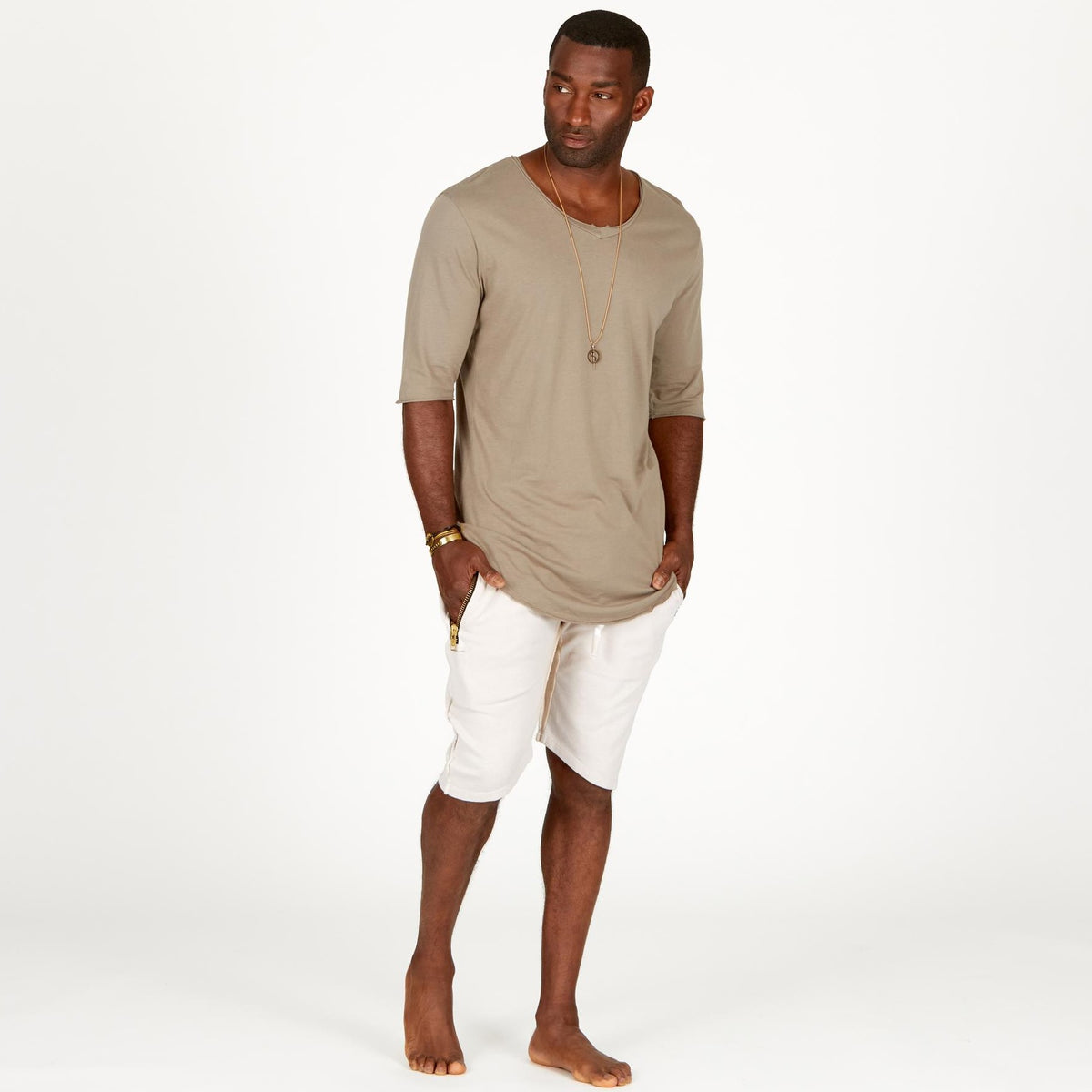 A man modeling white stone milanos mid shorts