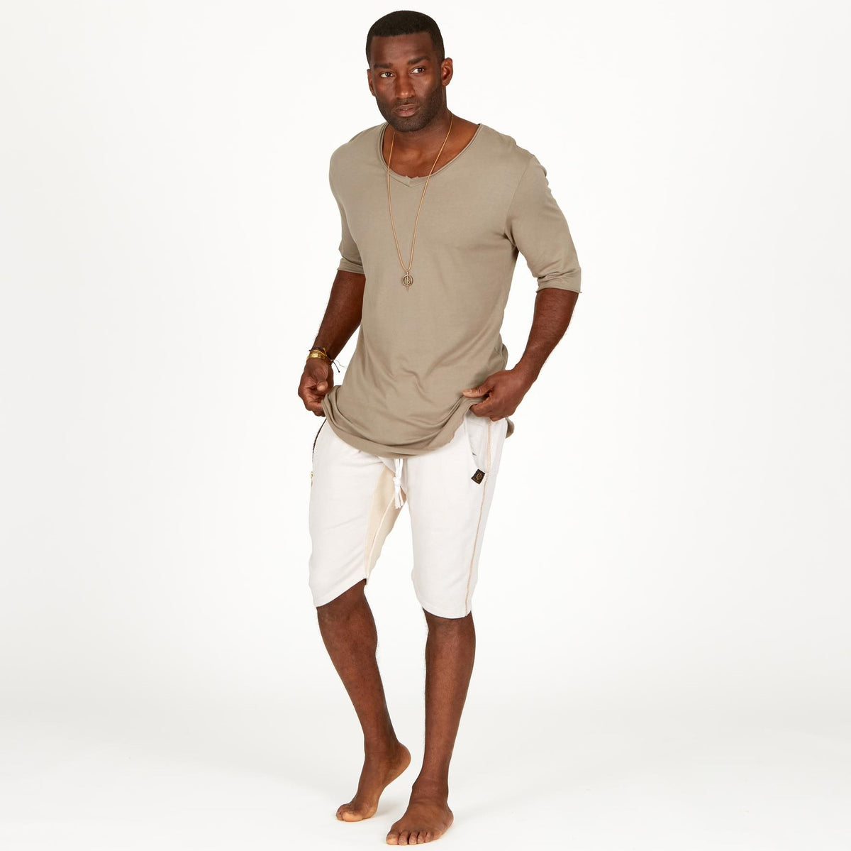 A man modeling white stone milanos mid shorts