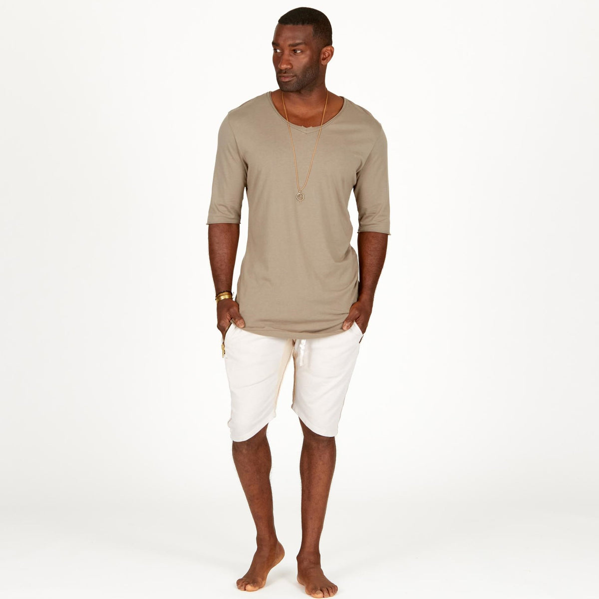 A man modeling white stone milanos mid shorts
