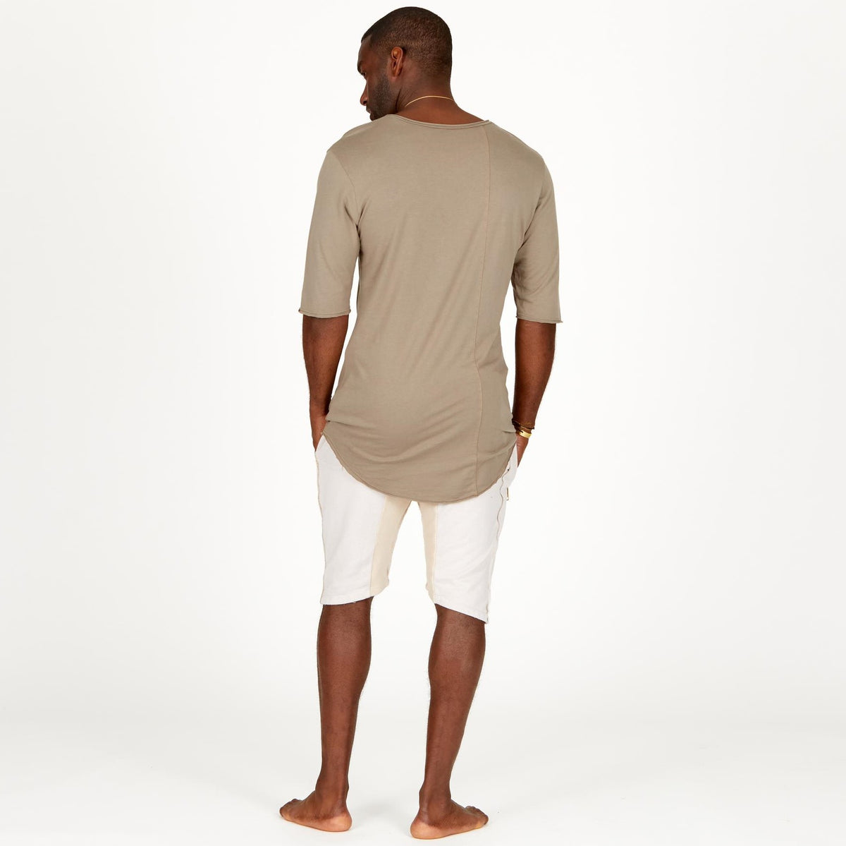 A man modeling white stone milanos mid shorts