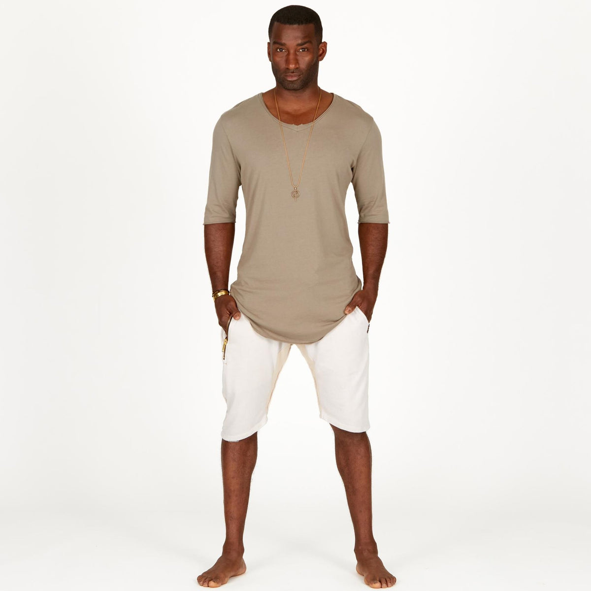 A man modeling white stone milanos mid shorts