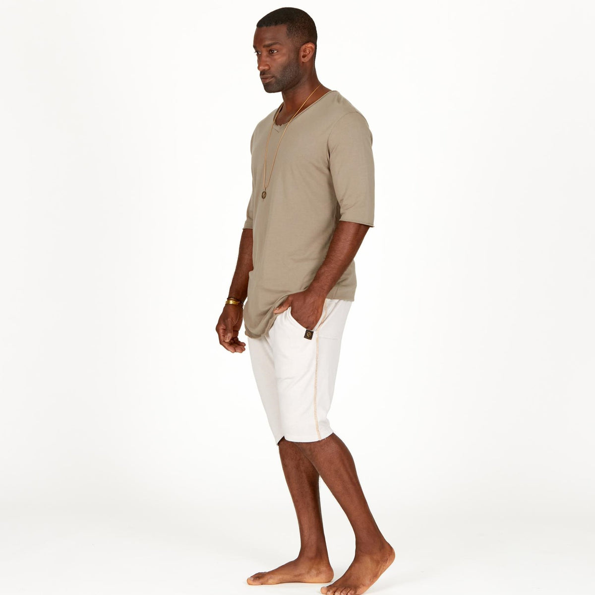 A man modeling white stone milanos mid shorts