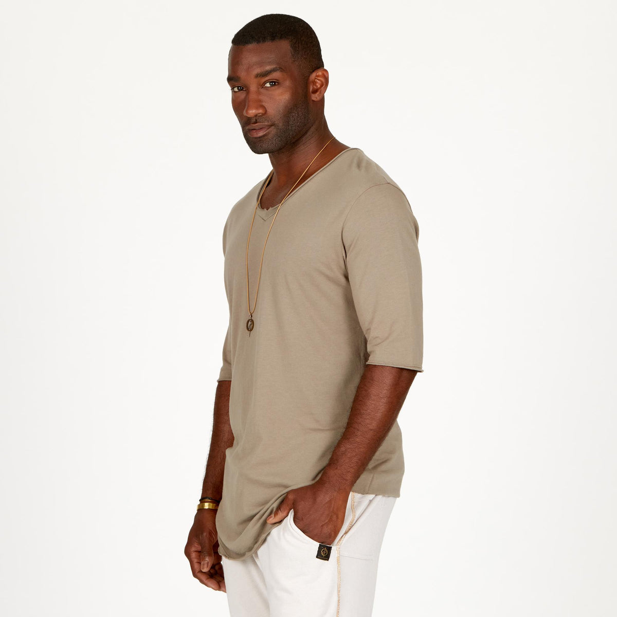 A man modeling white stone milanos mid shorts