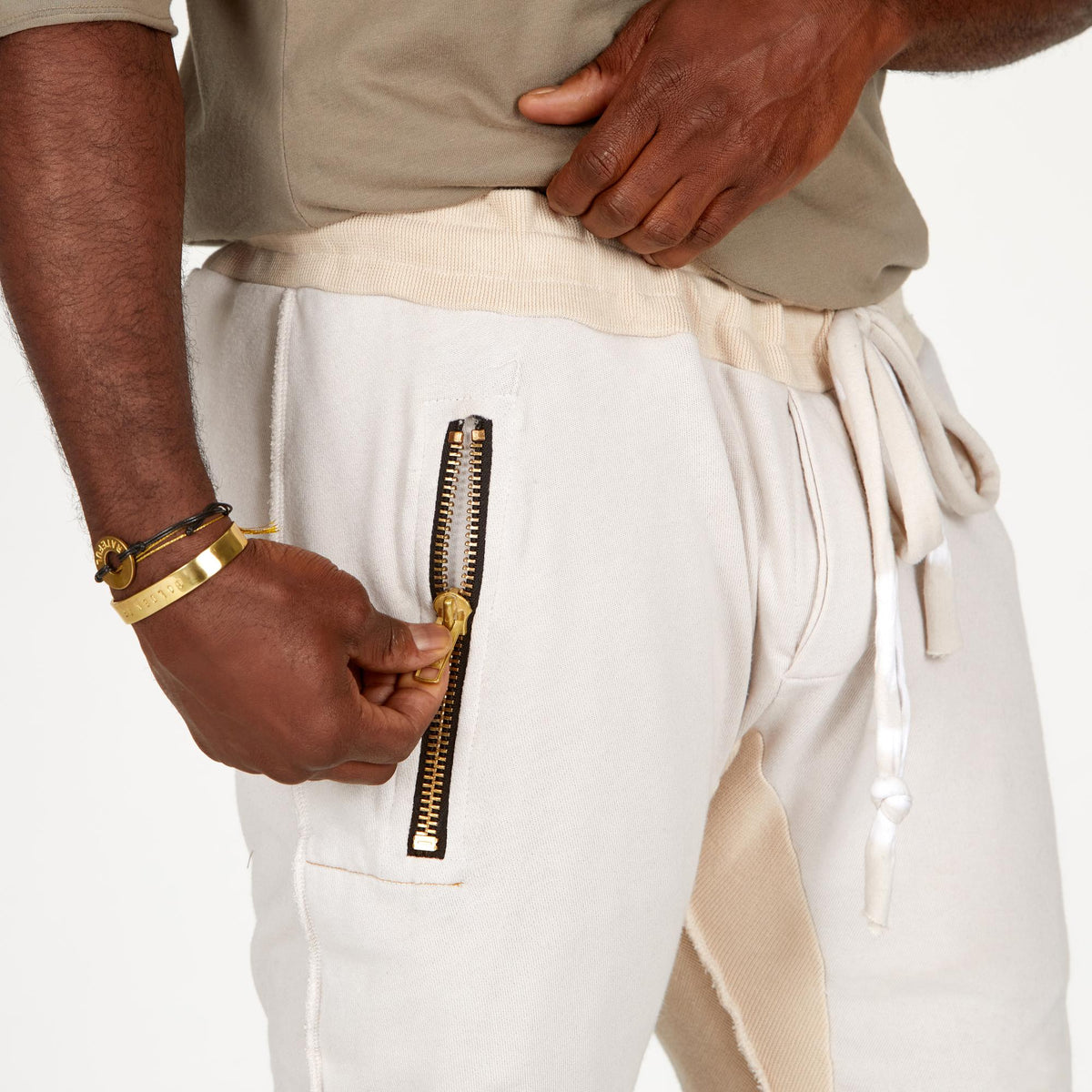 A man modeling white stone milanos mid shorts