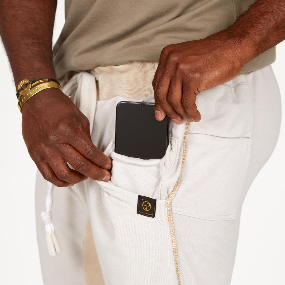 A man modeling white stone milanos mid shorts