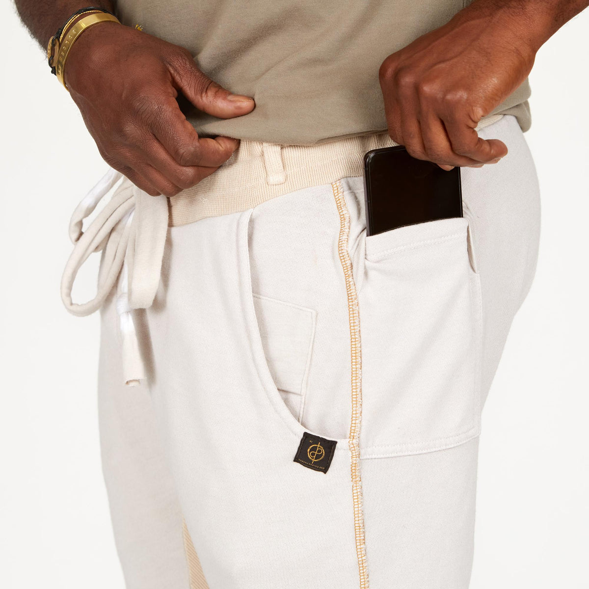 A man modeling white stone milanos mid shorts