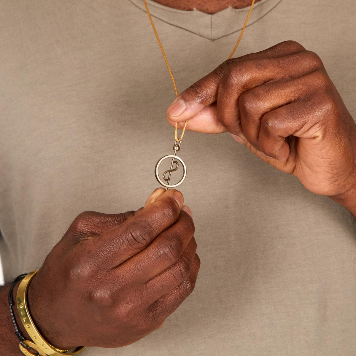 A model showcasing the 108 Talisman Necklace in Antique Gold