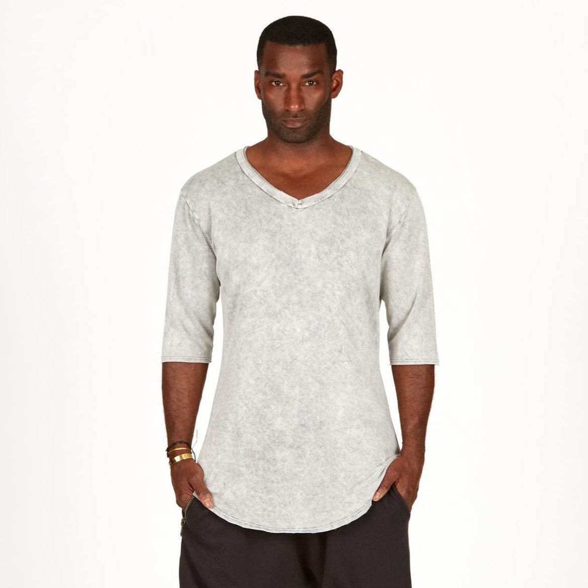 A man modeling in a grey mineral sweater v neck shirt