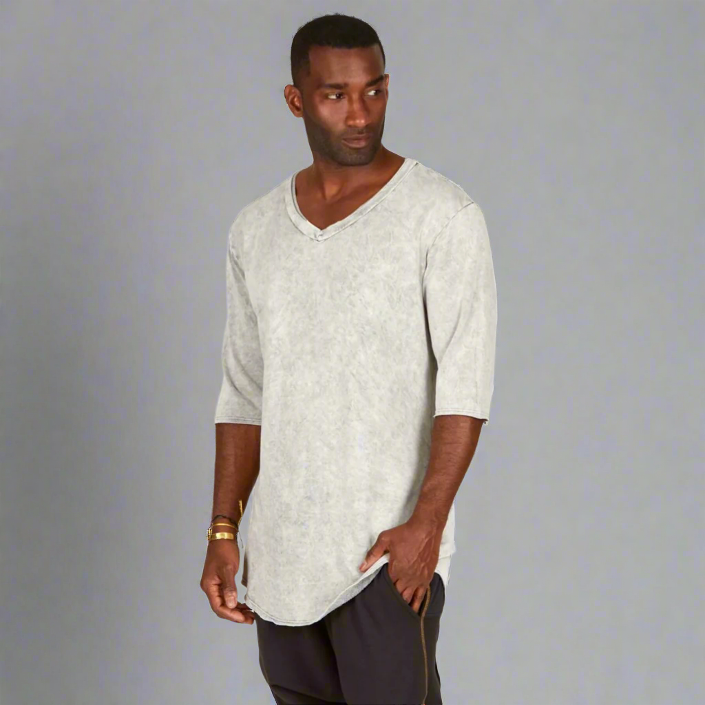 A man modeling in a grey mineral sweater v neck shirt