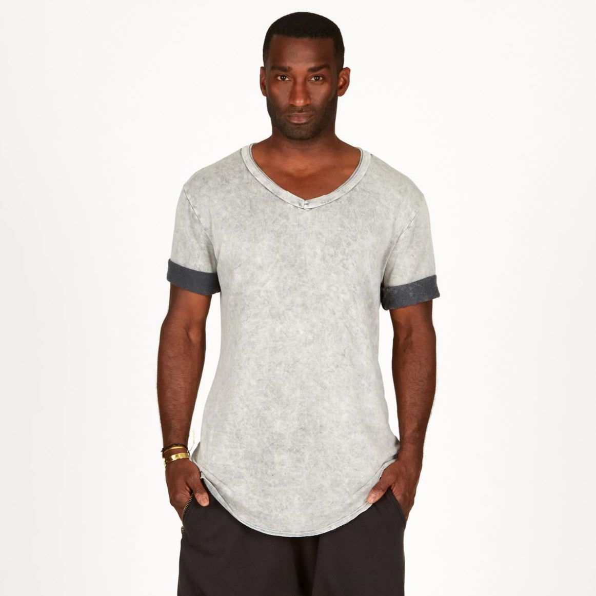 A man modeling in a grey mineral sweater v neck shirt