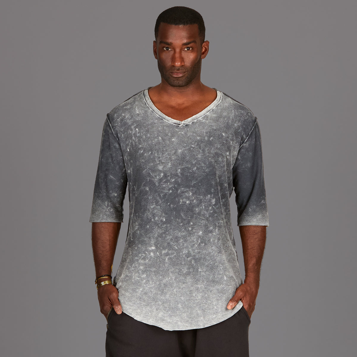 A man wearing the One Golden Thread Fleece Sweater v neck shirt in  grey mineral color