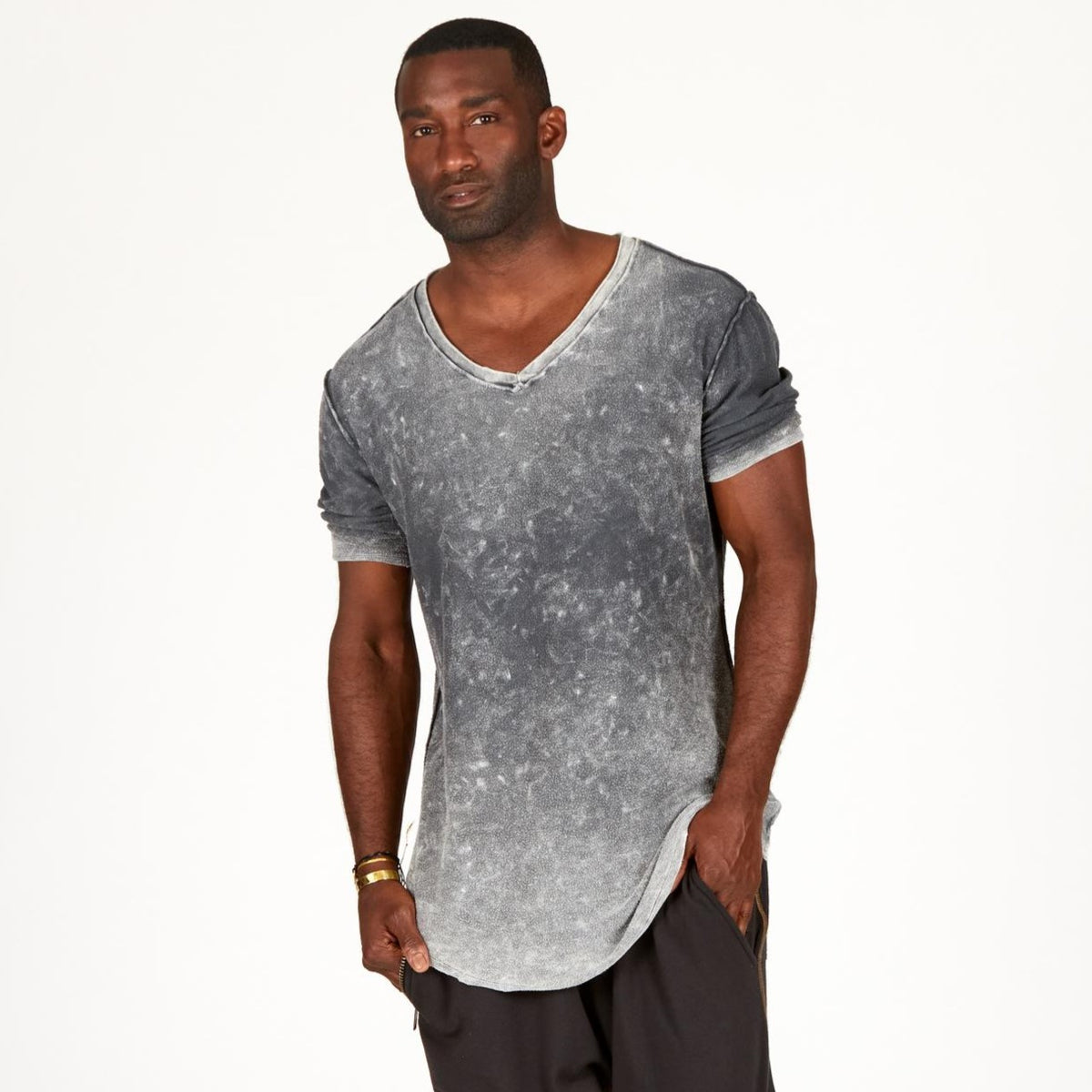 A man modeling in a grey mineral sweater v neck shirt