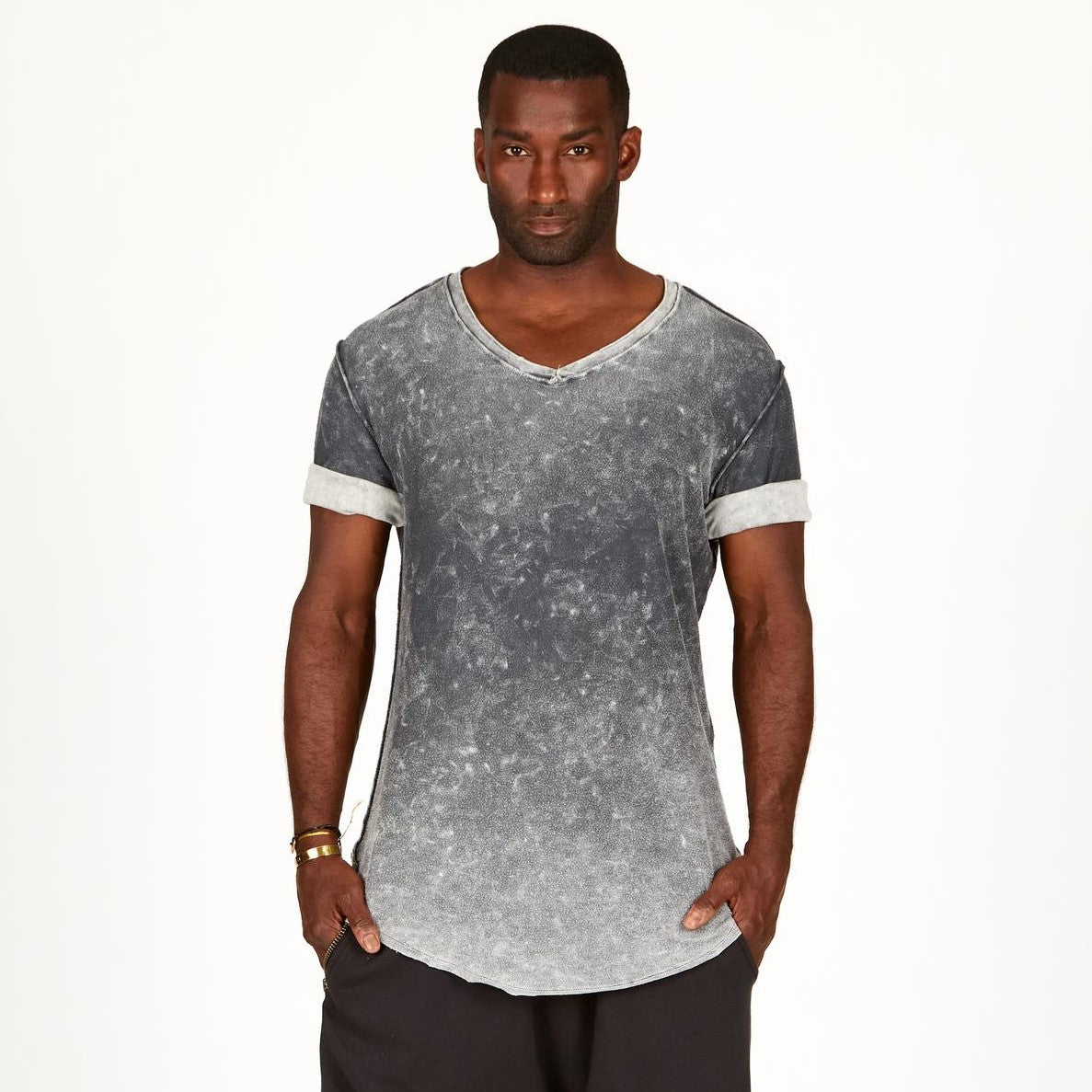 A man modeling in a grey mineral sweater v neck shirt