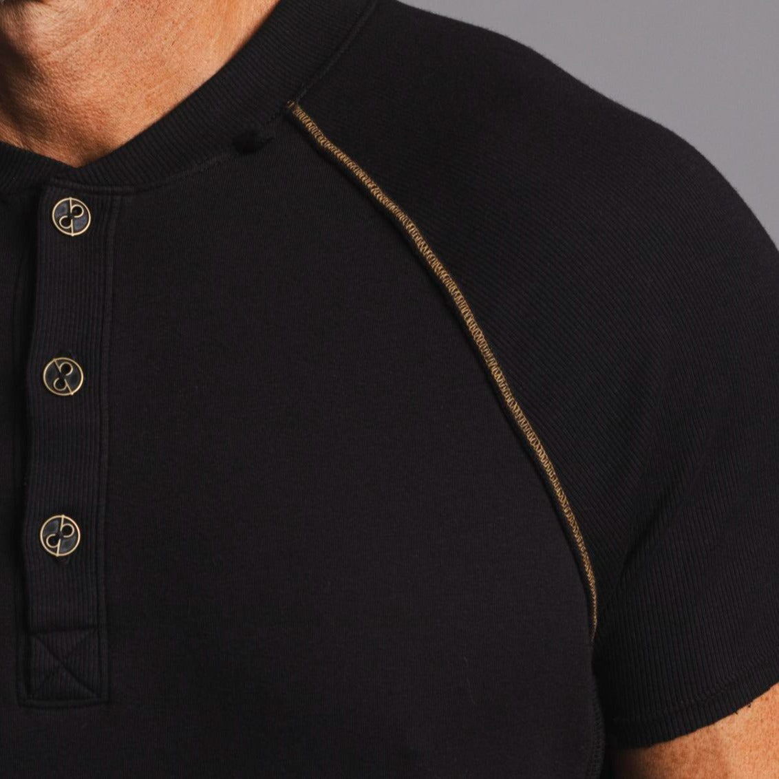 Man modeling a black Short Sleeve Henley shirt